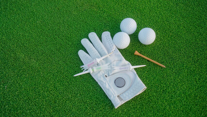 Close up of golf equipment on green grass.