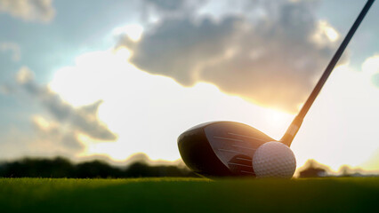 Golf clubs and balls on a green lawn in a beautiful golf course with morning sunshine.