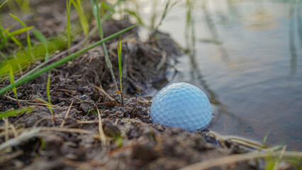 Problems and obstacles of Golf balls are in danger from water. White golf ball falls into the water...
