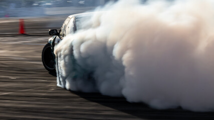 Car drifting, Blurred image diffusion race drift car with lots of smoke from burning tires on speed track, Car drifting on speed track, Professional driver drive drifting car. © Kalyakan