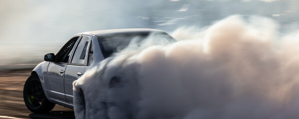 Car drifting, Blurred image diffusion race drift car with lots of smoke from burning tires on speed track, Car drifting on speed track, Professional driver drive drifting car. © Kalyakan