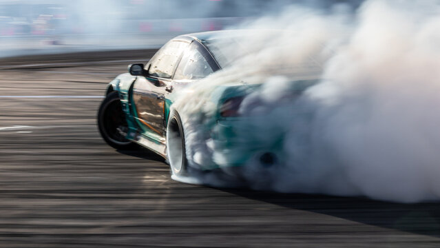 Car drifting, Blurred image diffusion race drift car with lots of smoke from burning tires on speed track, Car drifting on speed track, Professional driver drive drifting car.