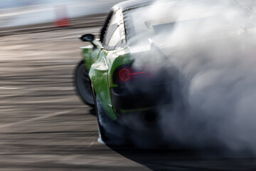 Car drifting, Blurred image diffusion race drift car with lots of smoke from burning tires on speed track, Car drifting on speed track, Professional driver drive drifting car. © Kalyakan