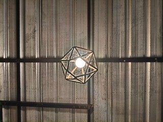 Geometric Pendant Light Fixture Hanging from Metal Ceiling