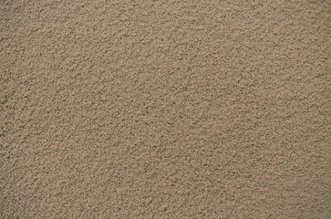 Sandy brown textured background with small grains