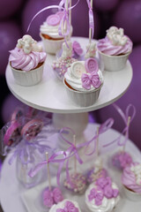 Purple cupcakes with decor for birthday party in restaurant.