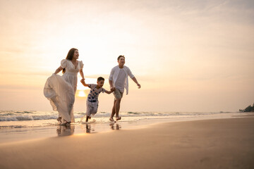 Family holiday vacation beach. Asian happy family outdoors summer travel. Fun families outdoors. Family vacation beach. Life assurance plan. Families financial planning Joyful relaxing Playing outside