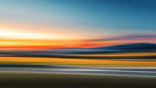 Blurred sunset over a landscape.  Motion-blurred colors blend into horizon