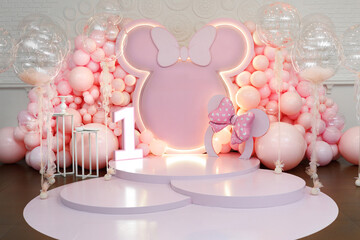 Birthday party for 1 year old girl on a background photo wall. Decorated with helium balloons.