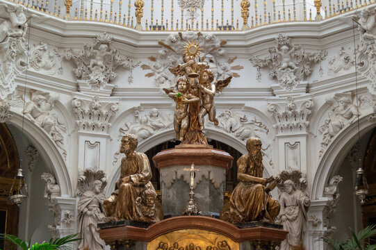 Detail of ornate golden tabernacle statues and white baroque stucco plasterwork in Sagrario chapel of Asuncion church in Priego de Cordoba, Spain.
