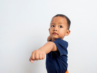 Portrait of strong and determined asian boy wearing casual t-shirt standing on isolated white...