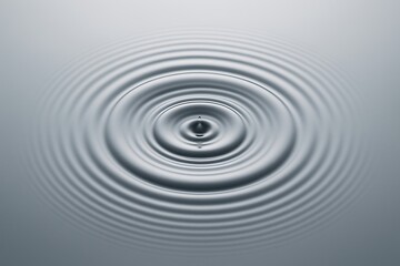 Concentric ripples expanding outward on a smooth water surface