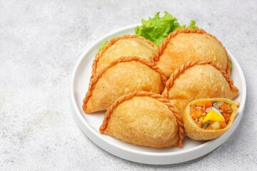 Pastel Goreng in Indonesia, pastel refers to a type of kue filled with meat, vegetables, and rice vermicelli deep fried in vegetable oil. It is consumed as a snack and commonly sold in Indonesian trad