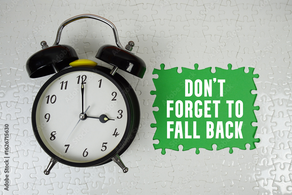 Poster don't forget to fall back text with alarm clock on green backgroun