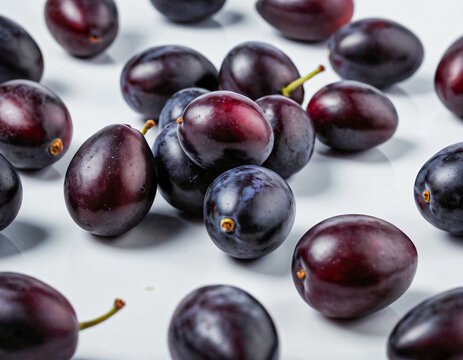 Single and clustered java plums placed neatly, tropical fruit close-up