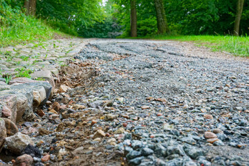 Damaged gravel walkway in Flensburg after heavy rainfall erosion