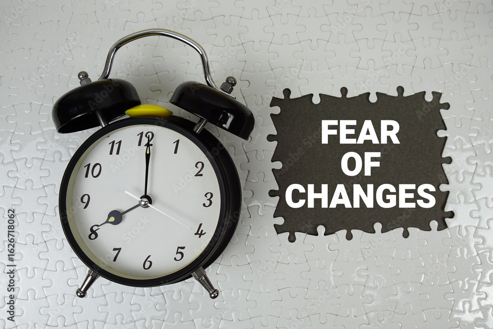 Poster fear of changes text with alarm clock on gray background