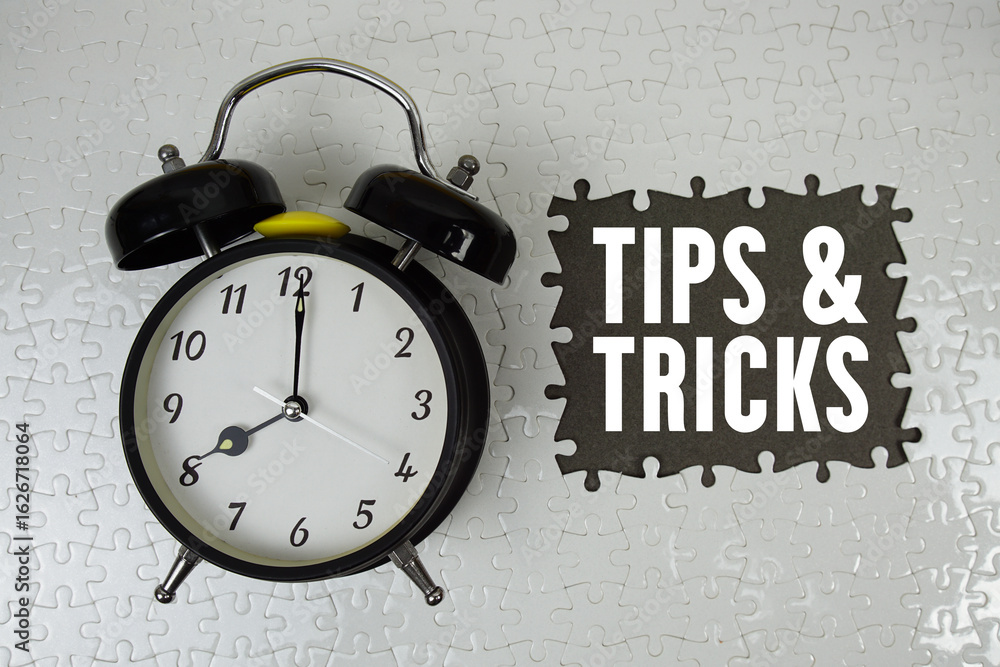 Poster tips and tricks text with alarm clock on gray background