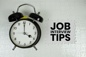 Job Interview Tips text with alarm clock on white background