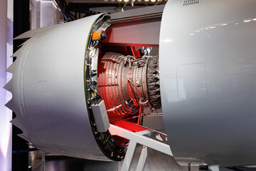 Detailed view of a large aircraft jet engine with visible turbine blades. Insides of the engine.