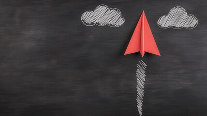 Red paper airplane flying upward with chalk drawn clouds on blackboard, symbolizing creativity and imagination in playful scene