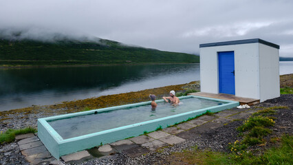 Relaxing in a tranquil geothermal hot spring overlooking Icelands stunning natural landscape