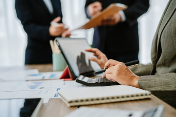 Team work discussing in valuation data in meeting room, three business people with accounting paper charts.