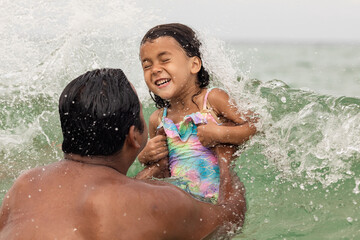 Father and daughter having fun in water during the summer vacation in Florida