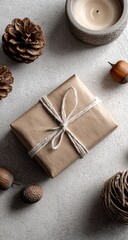 A light beige gift box, tied with natural twine, sits amidst autumnal decorations