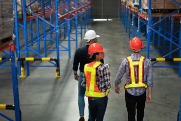 Team of warehouse workers inspecting inventory in a logistics facility. Represents supply chain...