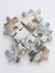 Obraz premium Five marble-patterned jigsaw puzzle pieces, arranged loosely, on a plain white background