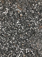 Overhead view of small gravel and crushed stones texture background gray wallpaper