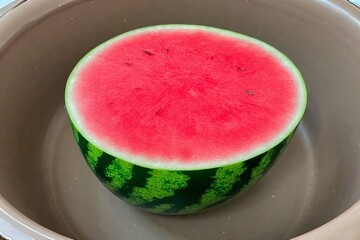 Whole and slice of ripe watermelon, heap of watermelon slices as background