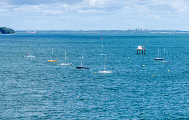 Small racing yachts and dinghies anchored in Fishbourne Harbour on Isle of Wight
