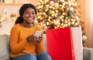 Online purchases and reviews of stores, cashback for buyers. Happy millennial african american...