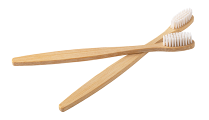 Two bamboo toothbrushes crossing on transparent background