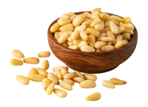 Pine nuts piled in wooden bowl on transparent background