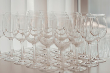 Stacked clear glassware ready for an event in a modern venue during an evening gathering