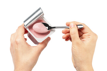 Woman holding pink yogurt in plastic cup and eating with spoon on transparent background