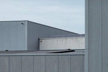 Fototapeta premium Industrial building showing solar panels on cloudy day