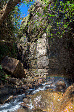 Falling water gives streaky rainbow in Rainbow Gorge