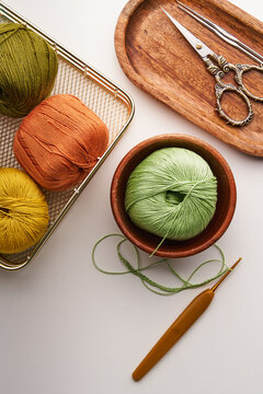 Top view of needlework tools and colorful yarns for crochet