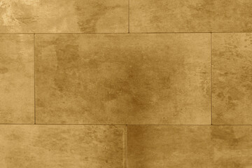 Fototapeta premium Distressed aged weathered gold tiles background backdrop. Interior design building product concept.