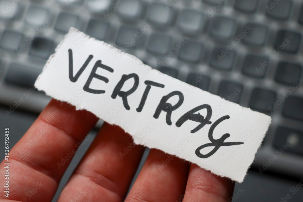 Poster a hand holding a piece of paper with the word vertrag written on it. the background features a blurr