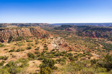 Stunning View of Palo Duro Canyon in Texas with Red Rock Formations Under a Clear Blue Sky