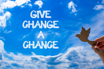 Give change a chance symbol. Concept words phrase Give change a chance on blue sky. Businessman's...