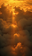 A breathtaking aerial view of the sky at sunset, with vibrant orange clouds illuminated by dramatic sunbeams breaking through.