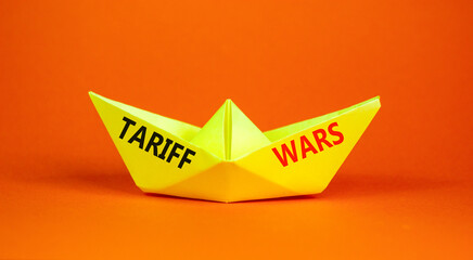 Trade tariff wars symbol. Concept word Tariff wars on beautiful yellow paper boat. Beautiful orange...