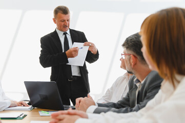 Senior manager explaining strategy during business meeting