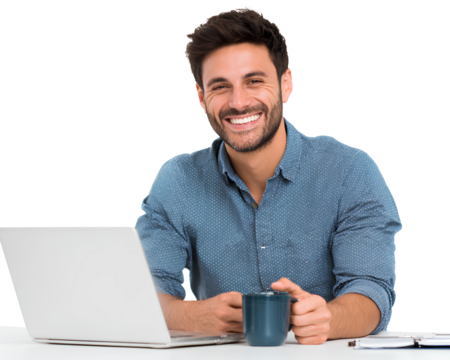 A happy young Arab man wearing a blue shirt, sitting at his desk with a laptop and coffee cup